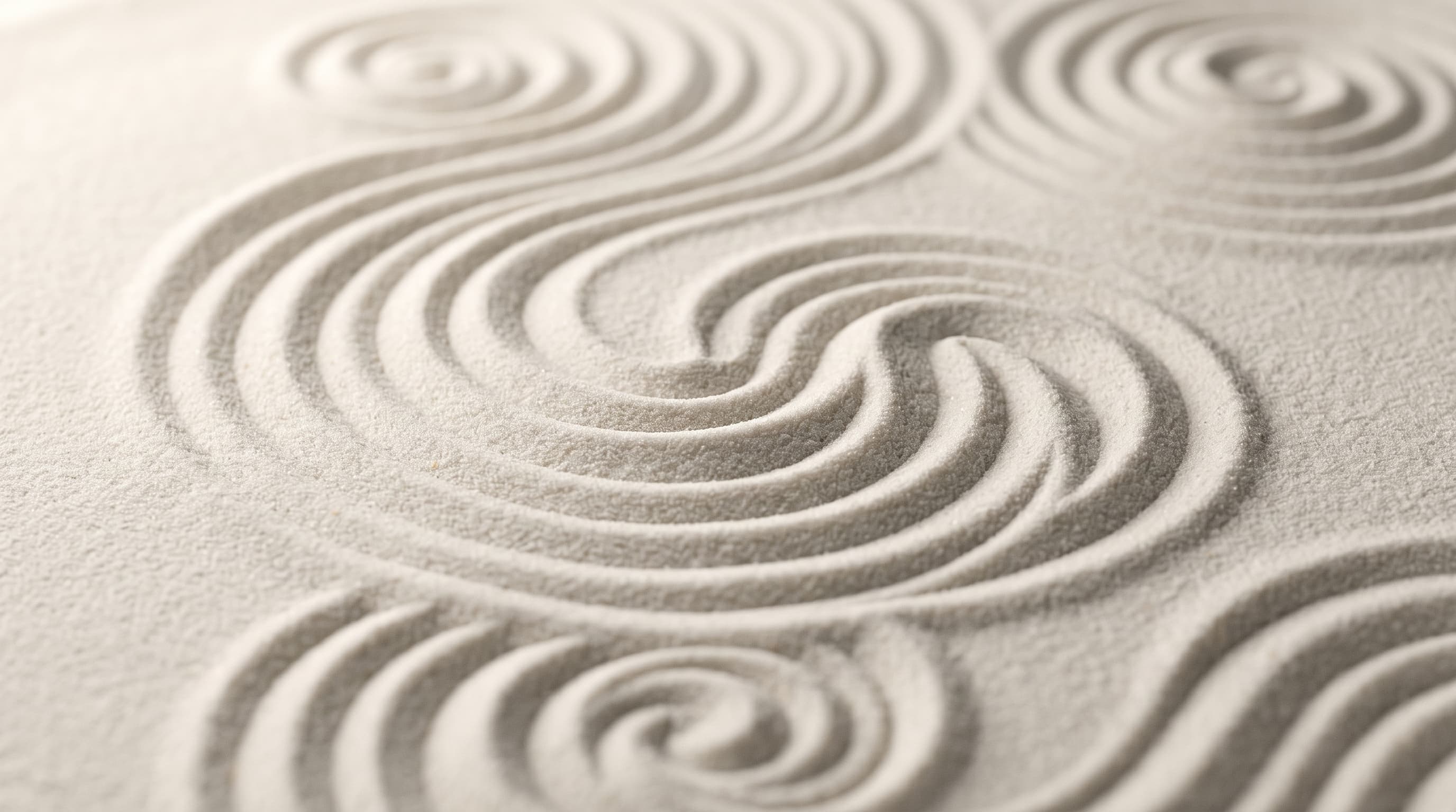 Swirling patterns raked into fine pale sand