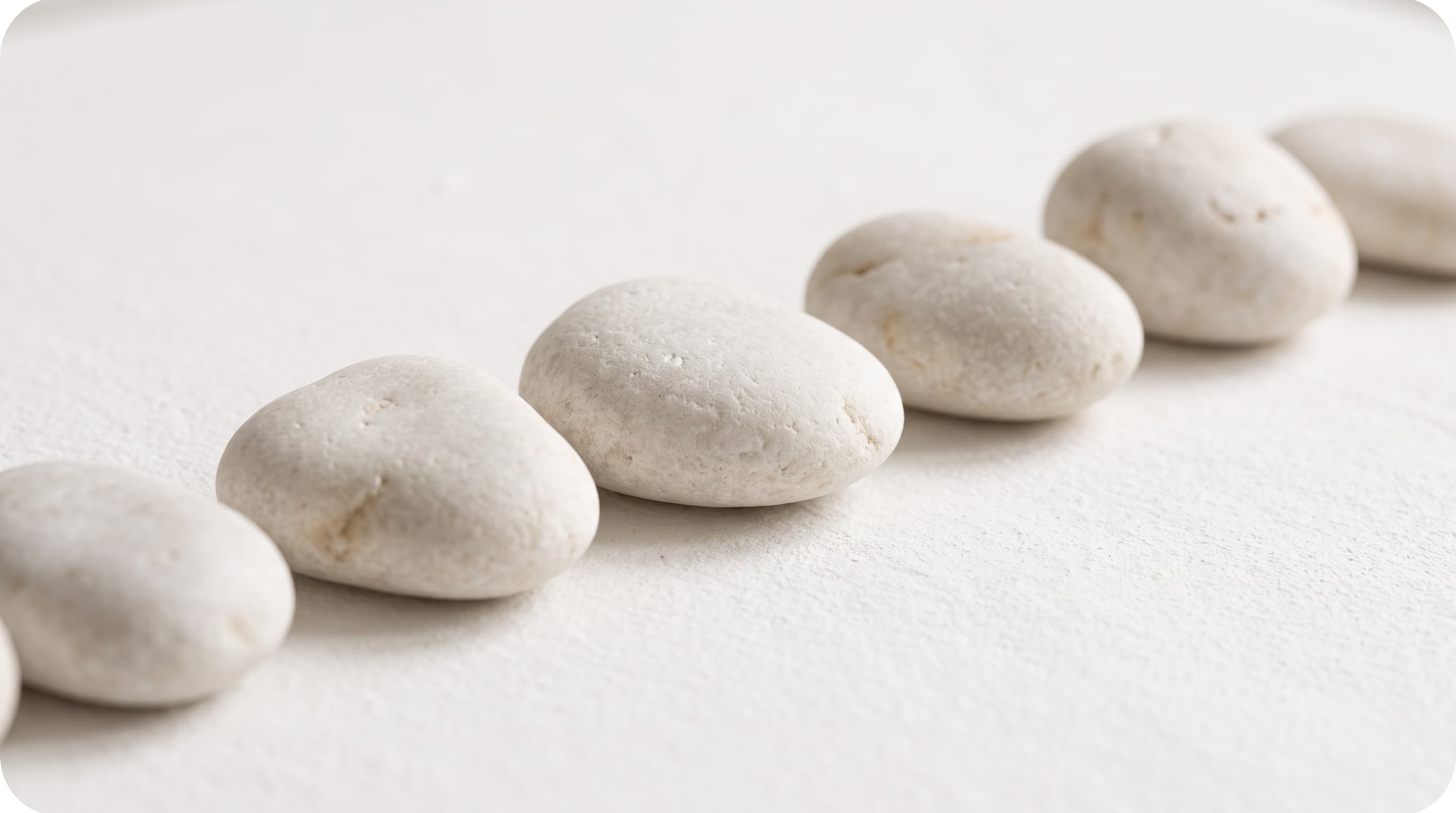 Smooth white stones arranged in a gentle row